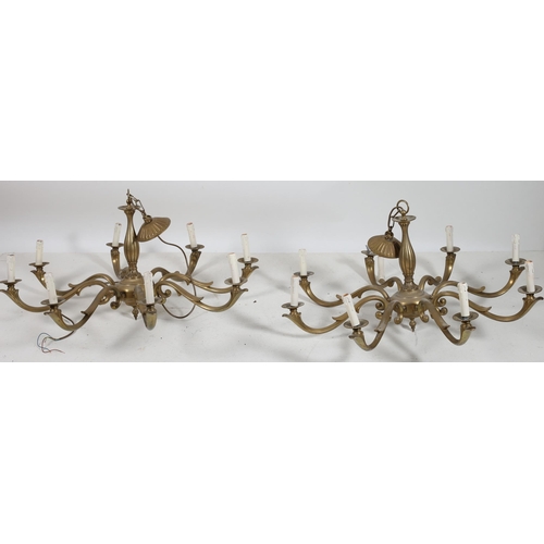 770 - A PAIR OF CONTINENTAL GILT BRASS EIGHT BRANCH CHANDELIERS the baluster column issuing eight scroll a... 