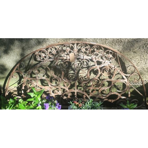 823 - A 19TH CENTURY WROUGHT IRON GRILL of demi lune outline the shaped top rail joined by square stretche... 