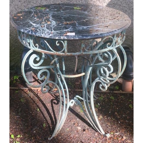 826 - A WROUGHT IRON PATIO TABLE of circular outline surmounted by a green veined marble top above a pierc... 