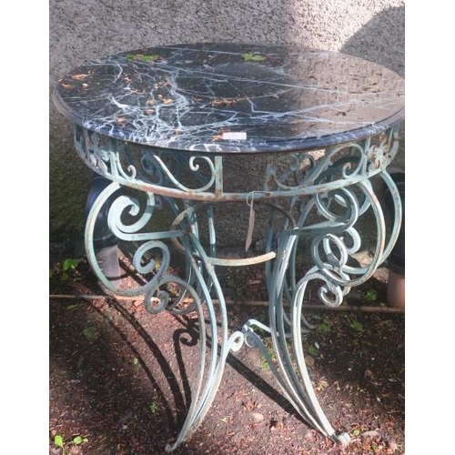 827 - A WROUGHT IRON PATIO TABLE of circular outline surmounted by a green veined marble top above a pierc... 