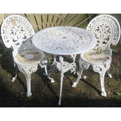 830 - A THREE PIECE ALUMINIUM AND CAST IRON PATIO SUITE comprising a pair of chairs each with an arched ba... 