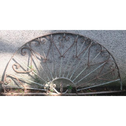 832 - A 19TH CENTURY WROUGHT IRON GRILL of demi lune outline the shaped top rail joined by cylindrical str... 