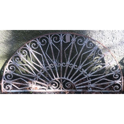 834 - A 19TH CENTURY WROUGHT IRON GRILL of demi lune outline the shaped top rail joined by cylindrical str... 