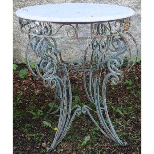 842 - A WROUGHT IRON PATIO TABLE of circular outline surmounted by a white veined marble top above a pierc... 