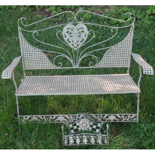 847 - A WROUGHT IRON FOLDING SEAT the scroll top rail above a pierced heart shaped splat with lattice work... 