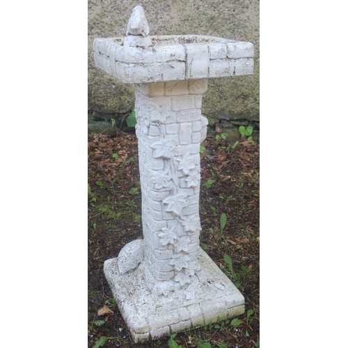 858 - A COMPOSITION STONE BIRD BATH of rectangular outline the shaped top above a foliate moulded column o... 