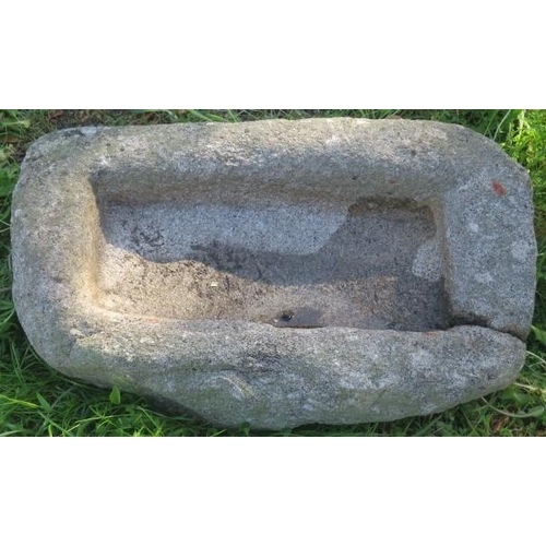 862 - A DRESSED GRANITE TROUGH of irregular outline 
24cm (h) x 83cm (w) x 47cm (d)