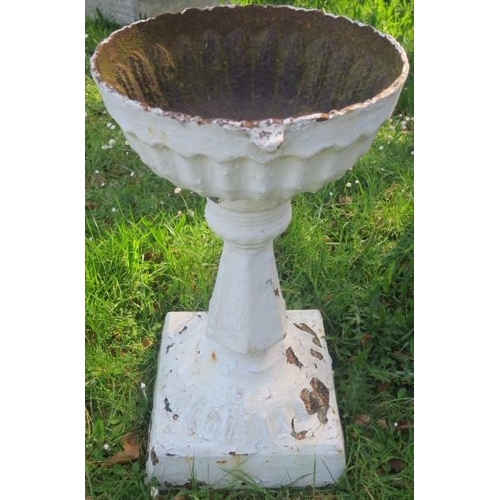 864 - A 19TH CENTURY CAST IRON PLANTER of cylindrical outline the shaped top above a faceted column on squ... 