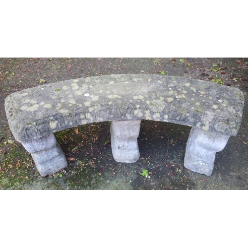 873 - A COMPOSITION SANDSTONE SEAT of demi lune outline the shaped top raised on three scroll supports the... 