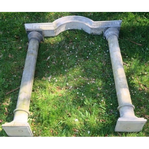 874 - A COMPOSITION STONE ARCH of rectangular bowed outline the shaped arch raised on Tuscan columns on a ... 