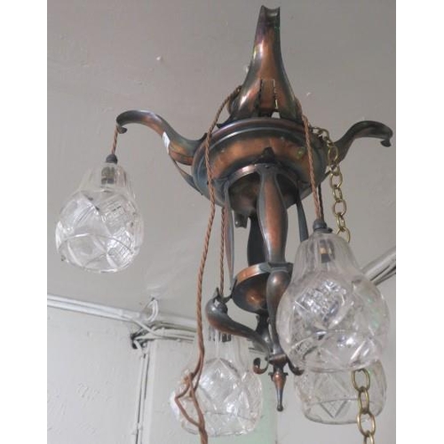 892 - AN ART NOUVEAU COPPER FOUR BRANCH CHANDELIER with stylised foliate arms issuing four cut glass shade... 