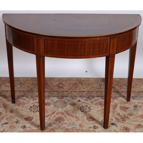 620 - A GEORGIAN MAHOGANY AND SATINWOOD CROSSBANDED SIDE TABLE of demi lune outline the shaped top with sa... 