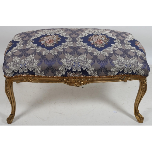 630 - A CONTINENTAL GILTWOOD AND UPHOLSTERED STOOL the rectangular needlework upholstered seat above a fol... 