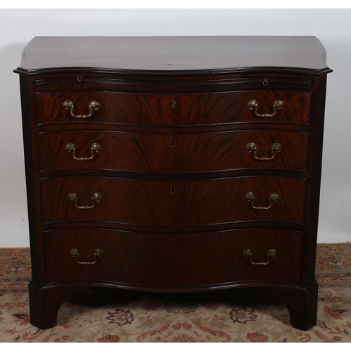 58 - A FINE GEORGIAN DESIGN MAHOGANY CHEST of serpentine outline the shaped top above a brush and slide a... 
