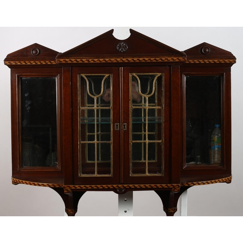 69 - A VINTAGE MAHOGANY WALL MOUNTED CABINET of architectural outline the architectural pediment above a ... 