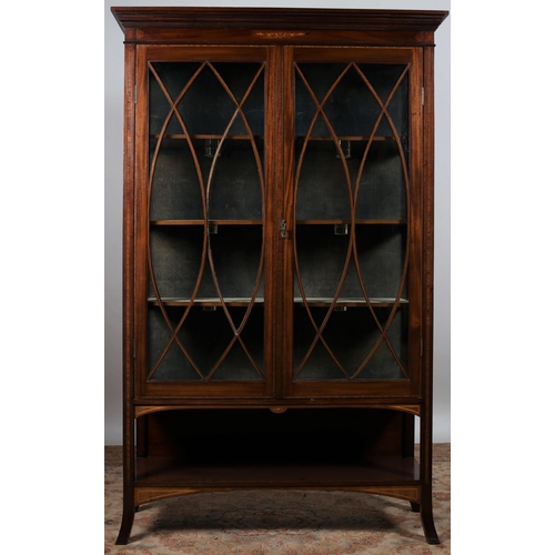 89 - AN EDWARDIAN MAHOGANY AND SATINWOOD INLAID CHINA DISPLAY CABINET the outswept moulded cornice above ... 