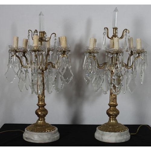 96 - A PAIR OF CONTINENTAL GILT BRASS AND CUT GLASS SIX BRANCH CANDELABRA with scroll arms and drip pans ... 