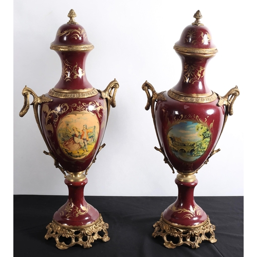 98 - A PAIR OF 19TH CENTURY CONTINENTAL PORCELAIN AND GILT BRASS URNS each of baluster form decorated wit... 