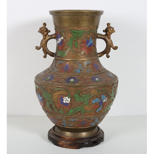 99 - AN ORIENTAL BRONZE AND CLOISONNE VASE of baluster form with figural handles raised on a pierced hard... 