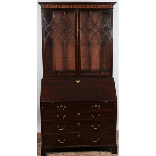 236 - A GEORGIAN MAHOGANY BUREAU BOOKCASE the dentil and blind fret cornice above a pair of astragal glaze... 