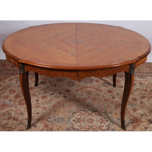 238 - A CONTINENTAL KINGWOOD MARQUETRY AND GILT BRASS MOUNTED DINING TABLE of oval outline the shaped top ... 