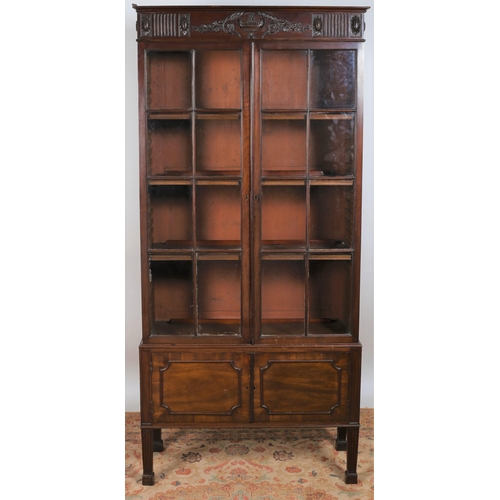 27 - A 19TH CENTURY ADAM'S DESIGN MAHOGANY BOOKCASE of rectangular outline the cornice carved with neo-cl... 