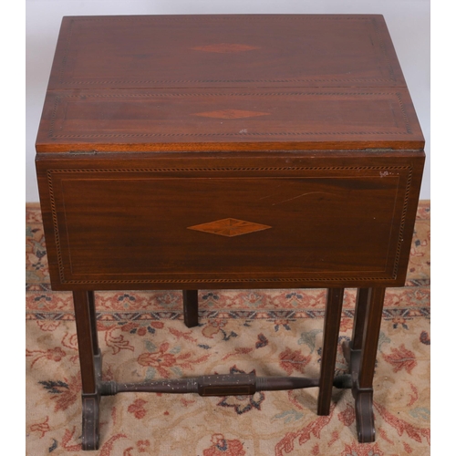 33 - A VINTAGE MAHOGANY INLAID SUTHERLAND TABLE the rectangular hinged top raised on dual moulded support... 