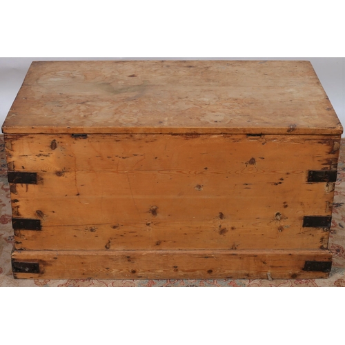 40 - A VINTAGE PINE AND STEEL BOUND TRUNK of rectangular outline the shaped top with hinged lid and steel... 