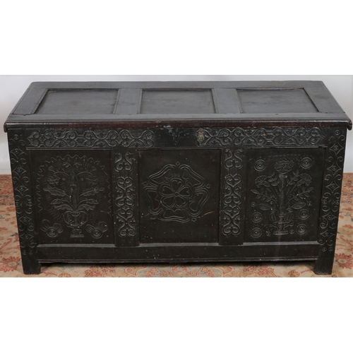 20 - A GEORGIAN CARVED OAK COFFER the rectangular hinged lid with panel inset above a carved three panel ... 