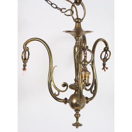 613 - A VINTAGE BRASS THREE BRANCH CHANDELIER the baluster column issuing three scroll arms with opaline g... 