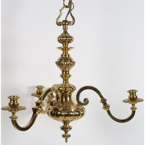 616 - A HEAVY BRASS THREE BRANCH CHANDELIER the baluster column issuing three scroll arms with circular dr... 