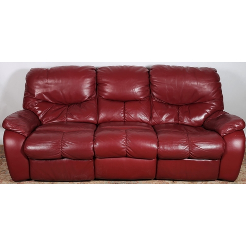 636 - A WINE HIDE UPHOLSTERED THREE SEATER SETTEE with shaped arms 
224cm (w)