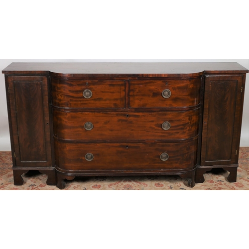 7 - A 19TH CENTURY MAHOGANY SIDEBOARD of rectangular bowed outline the shaped top above two short and tw... 