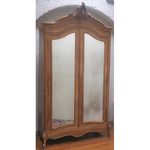 86 - A CONTINENTAL KINGWOOD WARDROBE the shaped cornice with carved foliate and shell cresting above a pa... 