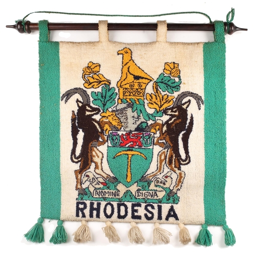 101 - Rhodesian banner suspended on a hardwood pole, of, depicting the Arms of Rhodesia. 'Sit Nomine Digna... 