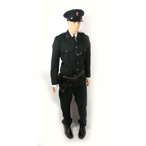 83 - Royal Ulster Constabulary uniform, comprising tunic, cap, shirt, tie trousers, shoes, and leather ho... 