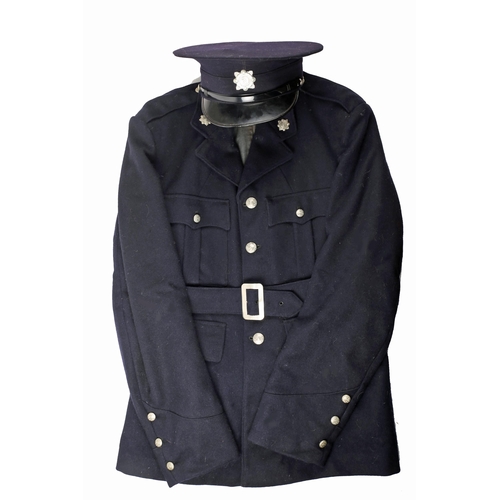 82 - 1950s Garda Siochana uniform. a navy wool Garda tunic, trousers and cap, marked 