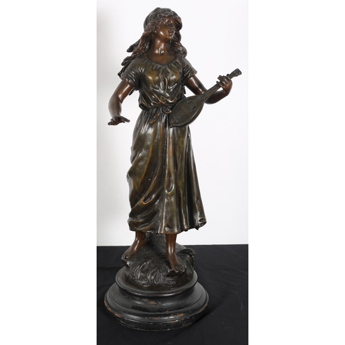 133 - after L. MOREAU 
A bronzed and spelter figure modelled as a young girls shown standing on a naturali... 