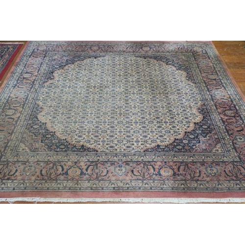 169 - A GHOM WOOL RUG the light pink ground with central panel filled with palmettes stylised flowerheads ... 