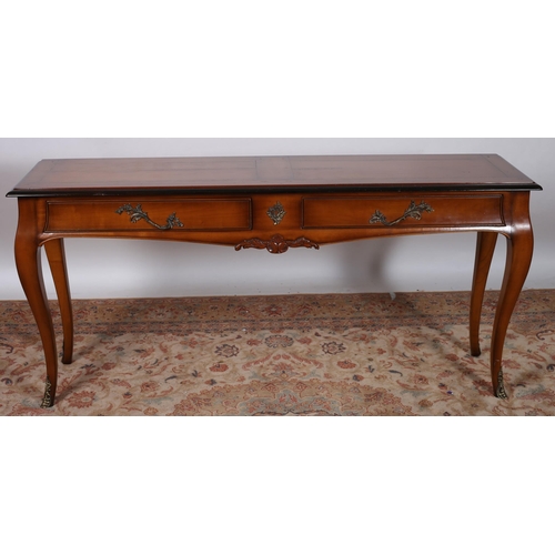 204 - A CHERRYWOOD CONSOLE TABLE of rectangular outline the shaped top above two frieze drawers with brass... 