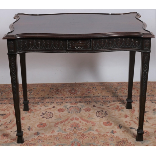 228 - AN ADAM DESIGN MAHOGANY CENTRE TABLE of serpentine outline the shaped top above a carved apron centr... 