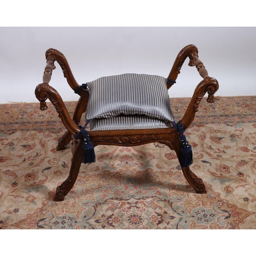 271 - A CONTINENTAL CARVED STAINED WOOD AND UPHOLSTERED STOOL with scroll arms joined by baluster stretche... 