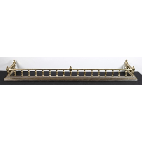 245 - A 19TH CENTURY POLISHED STEEL AND BRASS FENDER the cylindrical top rail above a stepped platform wit... 