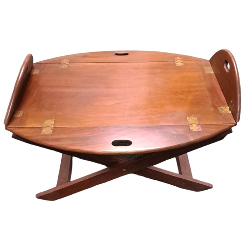 369 - A GEORGIAN MAHOGANY BUTLER'S TRAY ON STAND the oval hinged tray with carrying handles raised on an X... 