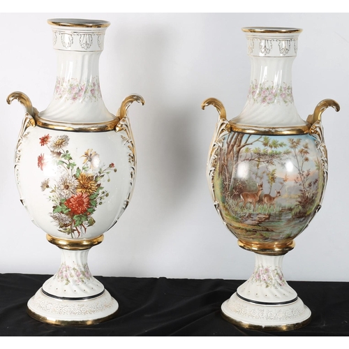 376 - A PAIR OF CONTINENTAL PORCELAIN VASES the white and gilt ground with floral decoration and wildlife ... 