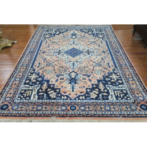 397 - A WOOL RUG the indigo and light pink ground with central panel filled with serrated panels, palmette... 