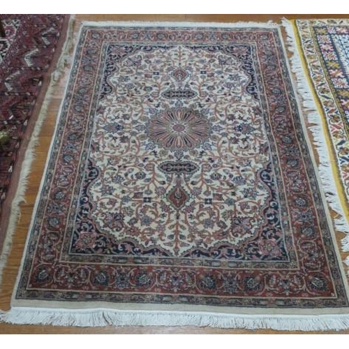 401 - A TIBRIZ WOOL RUG the beige ground with central panel filled with stylised flowerheads and foliage w... 