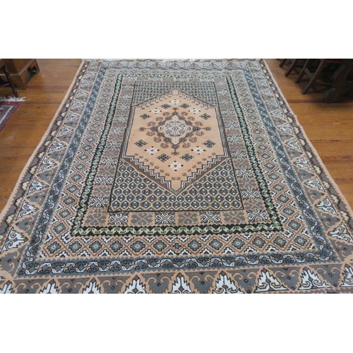 403 - A TUNISIAN WOOL RUG the light peach, brown and cream ground with central panel filled with hooks, pa... 