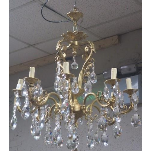 414 - A CONTINENTAL GILT BRASS AND CUT GLASS EIGHT BRANCH CHANDELIER the reeded scroll and foliate cast ar... 