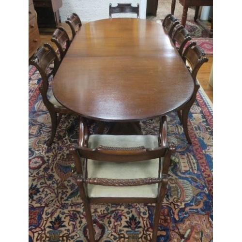 445 - A NINE PIECE REGENCY DESIGN MAHOGANY DINING ROOM SUITE comprising eight chairs each with a scroll to... 